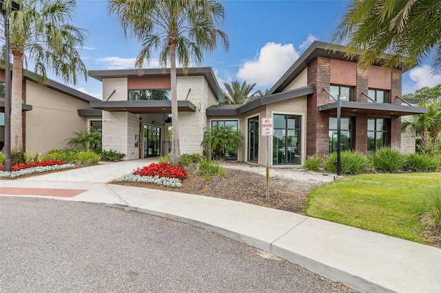 view of front of property with a front lawn and stucco siding