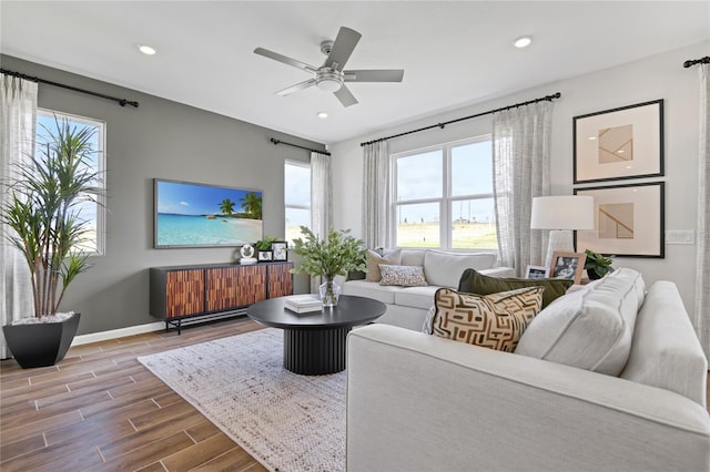 living area with recessed lighting, baseboards, ceiling fan, and wood finished floors