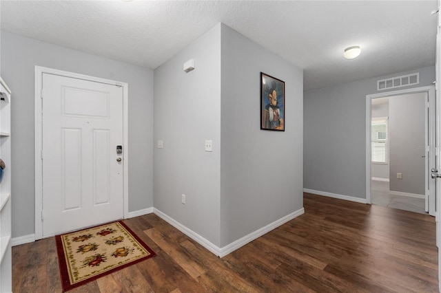 1532 Angler Ave, Kissimmee, FL 34746 - foyer entrance featuring a textured ceiling, visible vents, wood finished floors, and baseboards