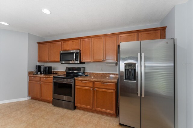 1532 Angler Ave, Kissimmee, FL 34746 - kitchen with stainless steel appliances, brown cabinetry, baseboards, and recessed lighting