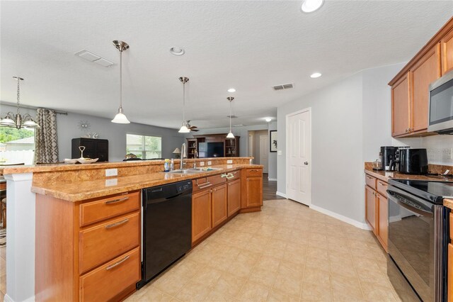 1532 Angler Ave, Kissimmee, FL 34746 - kitchen with brown cabinets, a sink, stainless steel appliances, pendant lighting, and visible vents