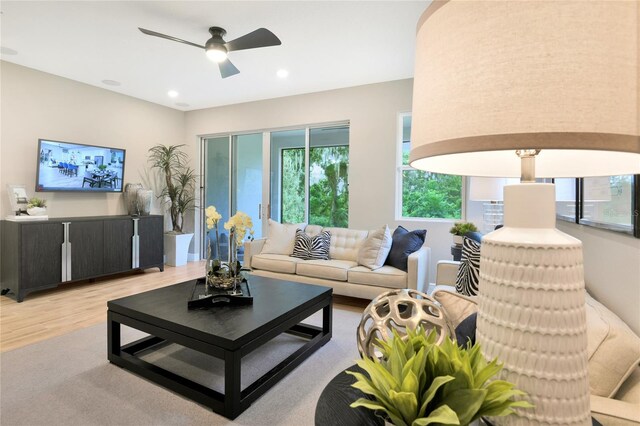 living area featuring recessed lighting, ceiling fan, light wood-type flooring, and a wealth of natural light