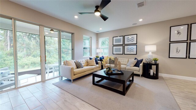 living area with recessed lighting, ceiling fan, visible vents, and baseboards