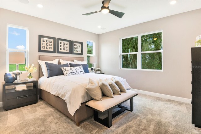bedroom with baseboards, recessed lighting, ceiling fan, and light carpet