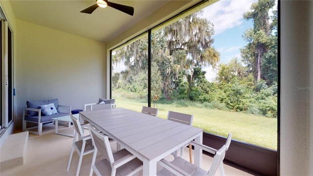 sunroom with outdoor dining space and ceiling fan