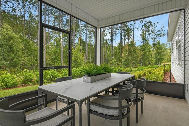 sunroom featuring outdoor dining area