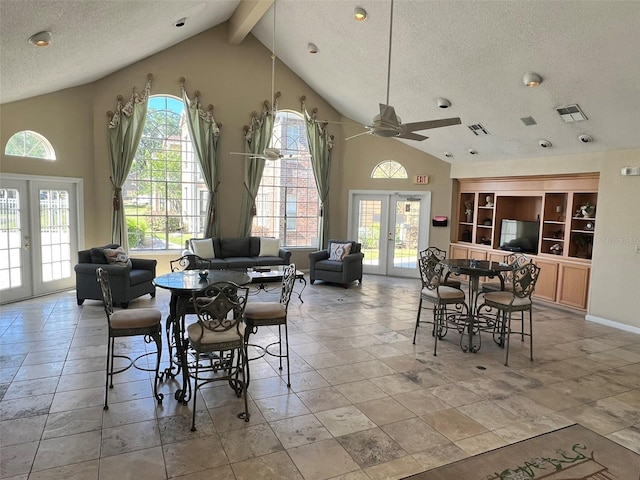 4301 Lizshire Ln Unit 306, Orlando, FL 32822 - dining space with french doors, a textured ceiling, ceiling fan, high vaulted ceiling, and beam ceiling