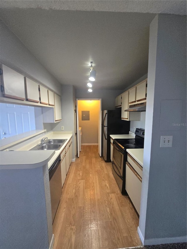 4301 Lizshire Ln Unit 306, Orlando, FL 32822 - kitchen with stainless steel appliances, under cabinet range hood, light wood-style floors, a sink, and light countertops