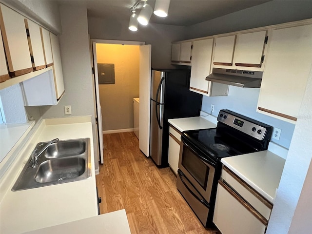 4301 Lizshire Ln Unit 306, Orlando, FL 32822 - kitchen featuring under cabinet range hood, appliances with stainless steel finishes, a sink, light wood finished floors, and light countertops