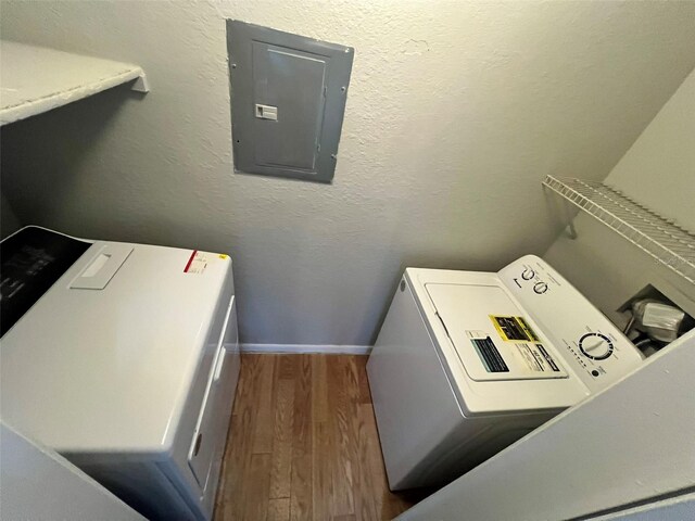 4301 Lizshire Ln Unit 306, Orlando, FL 32822 - laundry area featuring electric panel, wood finished floors, baseboards, and washer / dryer
