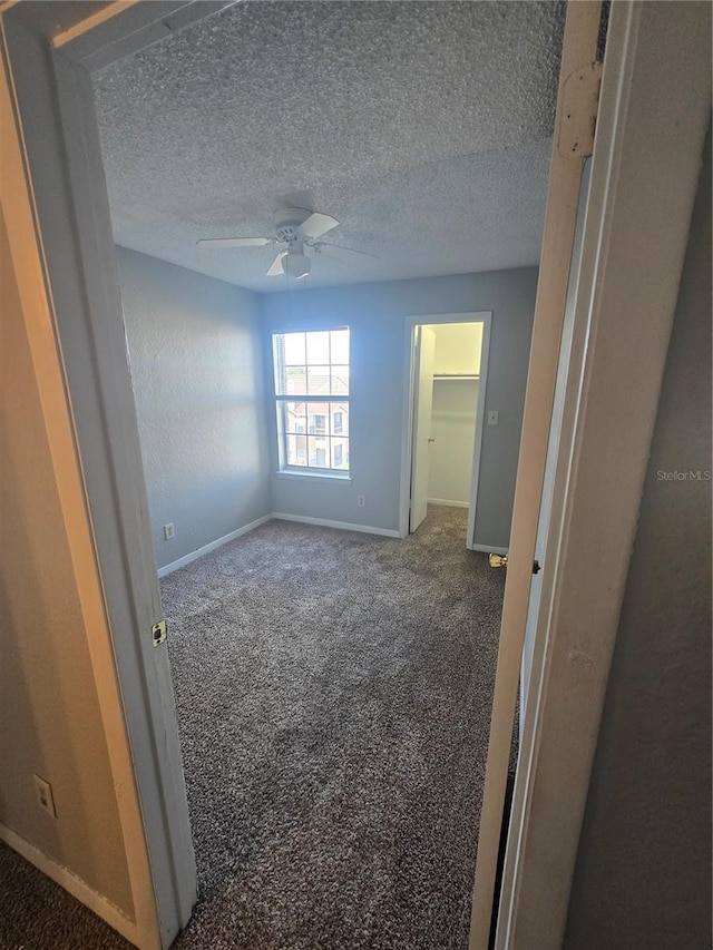 4301 Lizshire Ln Unit 306, Orlando, FL 32822 - carpeted spare room featuring baseboards, ceiling fan, and a textured ceiling