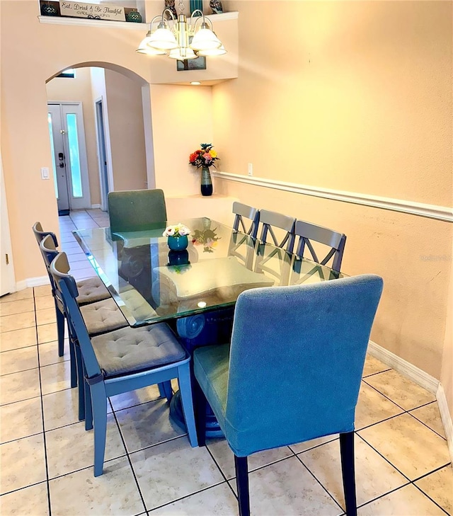 314 Saddle Ridge Dr, Davenport, FL 33896 - dining room featuring arched walkways, tile patterned floors, a notable chandelier, and baseboards