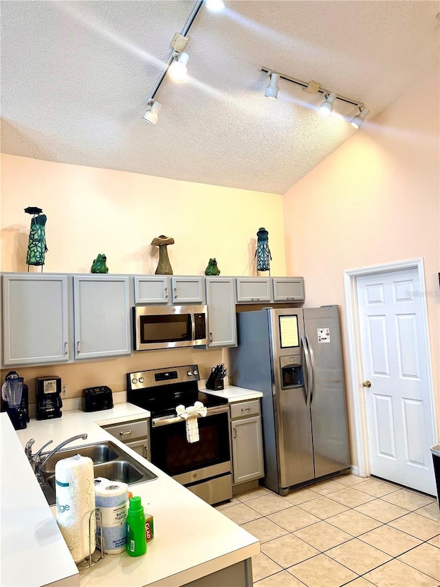 314 Saddle Ridge Dr, Davenport, FL 33896 - kitchen with track lighting, light countertops, a textured ceiling, gray cabinets, and stainless steel appliances
