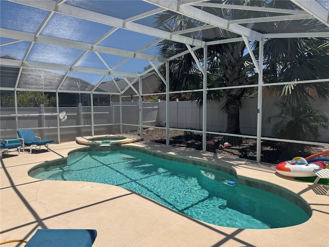 314 Saddle Ridge Dr, Davenport, FL 33896 - view of swimming pool featuring glass enclosure, a patio, a pool with connected hot tub, and a fenced backyard