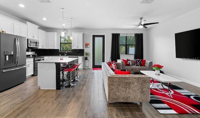 1231 Sandwedge St, Davenport, FL 33896 - living room with recessed lighting, a ceiling fan, wood finished floors, and visible vents