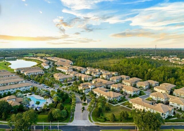 1231 Sandwedge St, Davenport, FL 33896 - aerial view at dusk with a water view, a residential view, and a wooded view