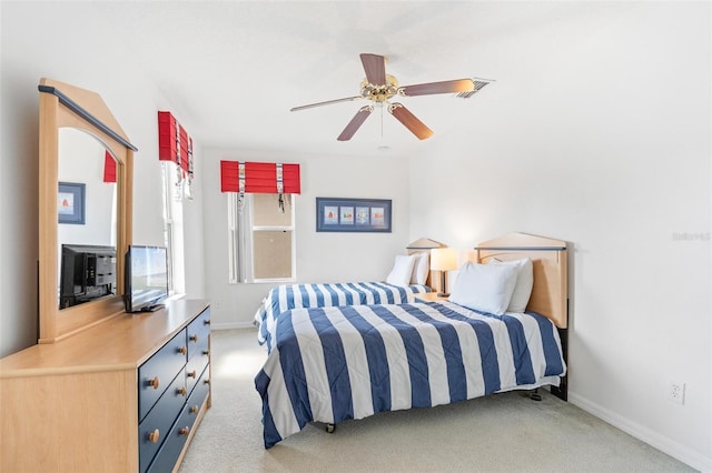 bedroom featuring baseboards, visible vents, light carpet, and ceiling fan