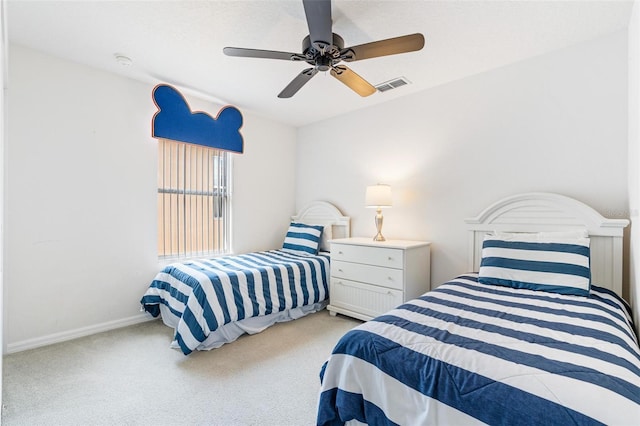 carpeted bedroom with visible vents, baseboards, and ceiling fan