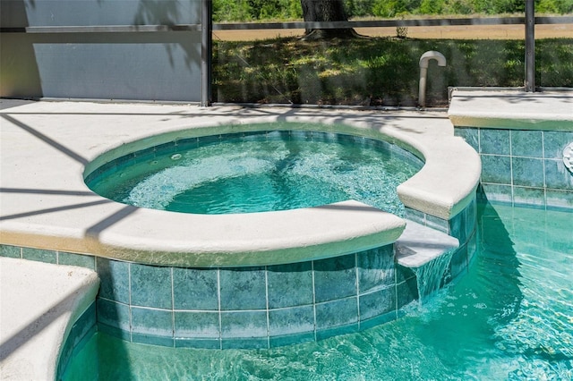 view of pool with an in ground hot tub