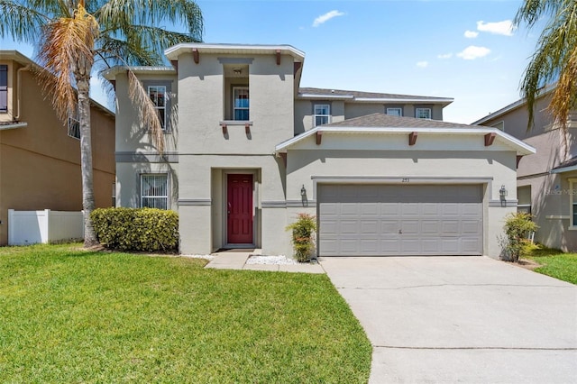 view of front of house with a garage, stucco siding, driveway, and a front yard