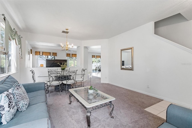 living room featuring carpet flooring, baseboards, an inviting chandelier, and visible vents