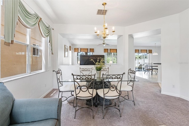 dining area featuring visible vents, carpet, baseboards, and a chandelier