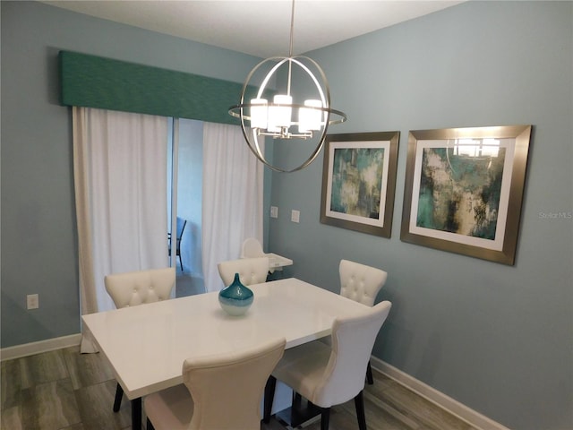 9079 Dogleg Dr, Davenport, FL 33896 - dining room with dark wood-style flooring, baseboards, and a chandelier
