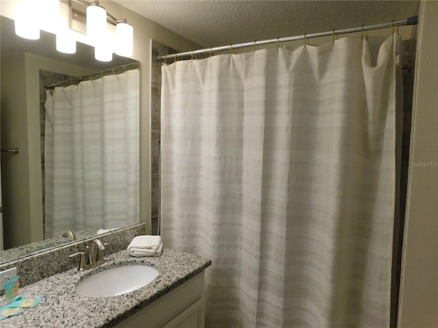 9079 Dogleg Dr, Davenport, FL 33896 - bathroom featuring vanity and a textured ceiling