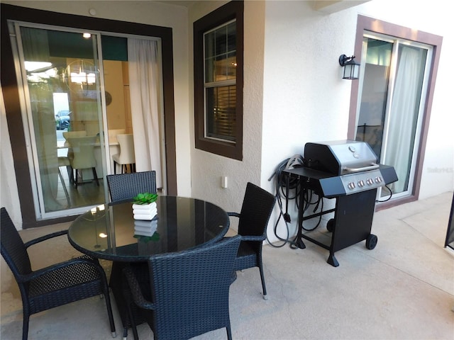 9079 Dogleg Dr, Davenport, FL 33896 - view of patio featuring a grill and outdoor dining space