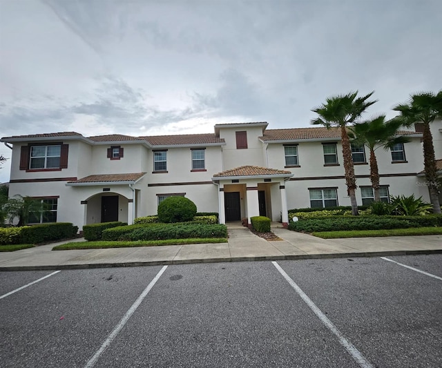 9079 Dogleg Dr, Davenport, FL 33896 - mediterranean / spanish home featuring uncovered parking, stucco siding, and a tile roof