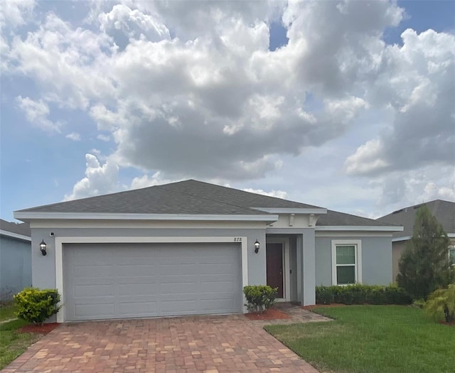 single story home featuring a shingled roof, stucco siding, decorative driveway, and a garage