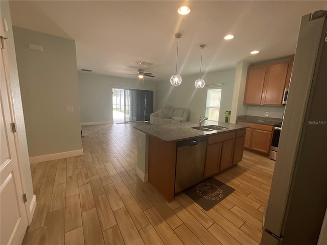 kitchen featuring a sink, light wood-style floors, plenty of natural light, and appliances with stainless steel finishes