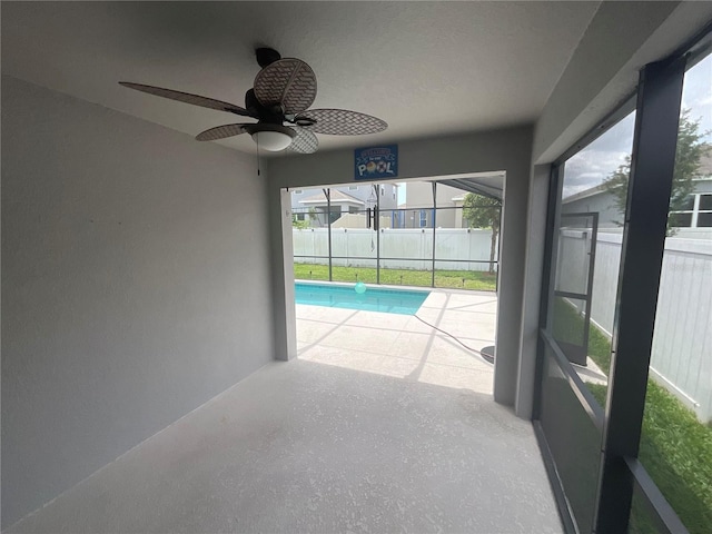 view of swimming pool featuring a patio, a lanai, fence, and ceiling fan