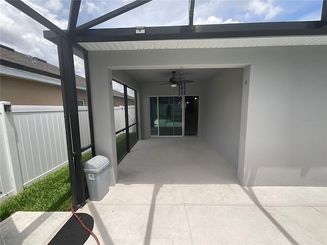 view of patio featuring fence and a ceiling fan