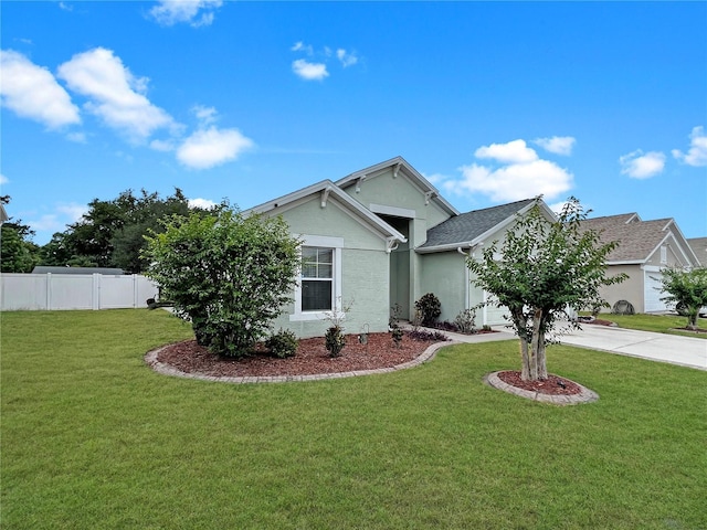 8439 Adele Rd, Lakeland, FL 33810 - ranch-style home with fence, concrete driveway, a garage, stucco siding, and a front lawn