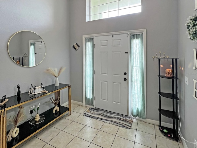 8439 Adele Rd, Lakeland, FL 33810 - foyer entrance with light tile patterned floors, baseboards, and a towering ceiling