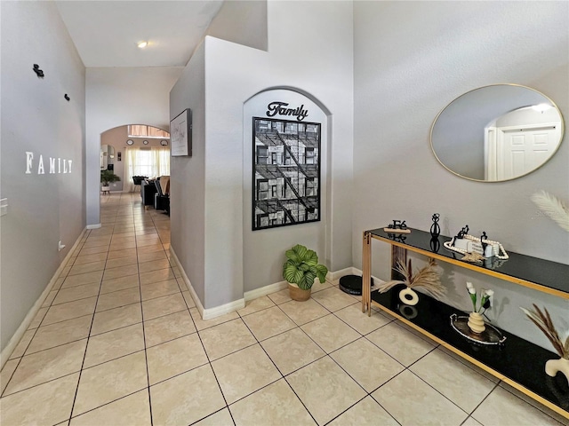 8439 Adele Rd, Lakeland, FL 33810 - corridor with light tile patterned flooring, arched walkways, and baseboards