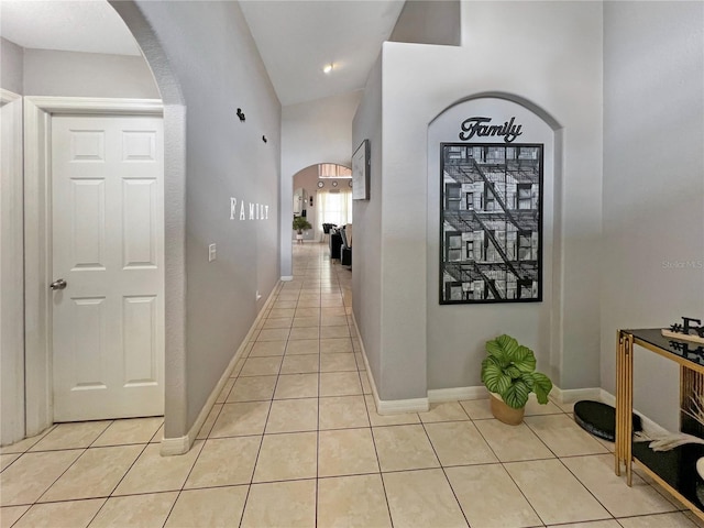 8439 Adele Rd, Lakeland, FL 33810 - hallway featuring light tile patterned floors, baseboards, and arched walkways