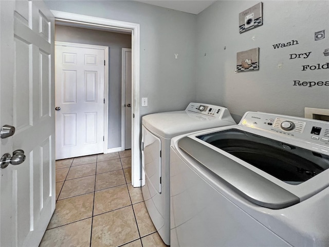 8439 Adele Rd, Lakeland, FL 33810 - washroom with washing machine and clothes dryer, laundry area, and light tile patterned floors