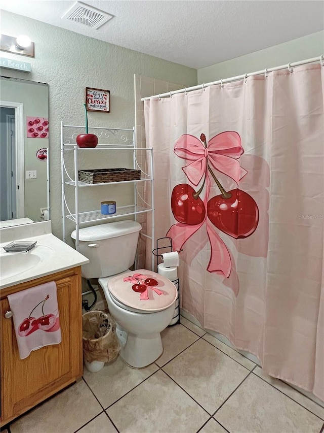 8439 Adele Rd, Lakeland, FL 33810 - bathroom featuring vanity, a textured wall, visible vents, and tile patterned flooring