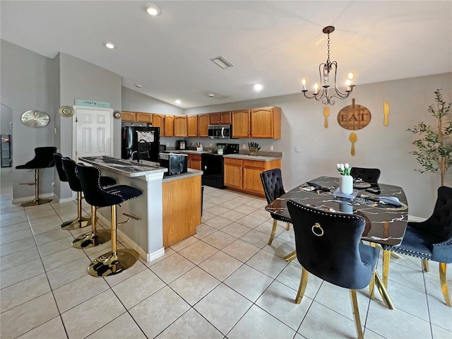 8439 Adele Rd, Lakeland, FL 33810 - kitchen with an inviting chandelier, visible vents, black appliances, decorative light fixtures, and lofted ceiling