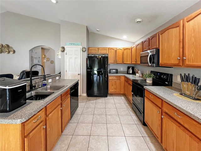 8439 Adele Rd, Lakeland, FL 33810 - kitchen featuring light tile patterned floors, a sink, arched walkways, black appliances, and vaulted ceiling