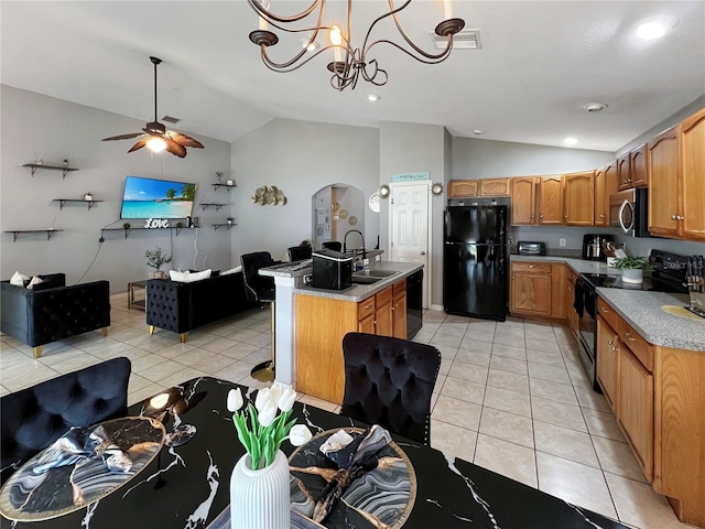 8439 Adele Rd, Lakeland, FL 33810 - kitchen featuring lofted ceiling, ceiling fan with notable chandelier, black appliances, and arched walkways