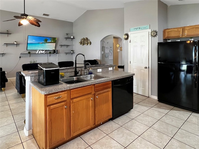 8439 Adele Rd, Lakeland, FL 33810 - kitchen with light tile patterned floors, arched walkways, black appliances, and a sink
