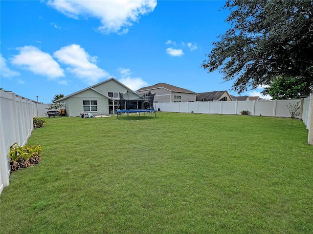 8439 Adele Rd, Lakeland, FL 33810 - view of yard featuring a trampoline and a fenced backyard