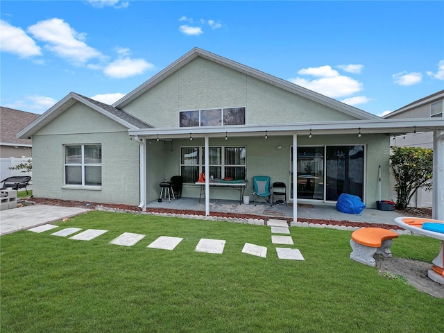 8439 Adele Rd, Lakeland, FL 33810 - rear view of house featuring a yard, a patio, and stucco siding