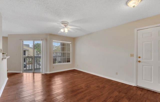 unfurnished room with baseboards, a textured ceiling, ceiling fan, and wood finished floors