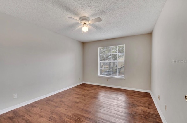 spare room featuring baseboards, a ceiling fan, a textured ceiling, and wood finished floors