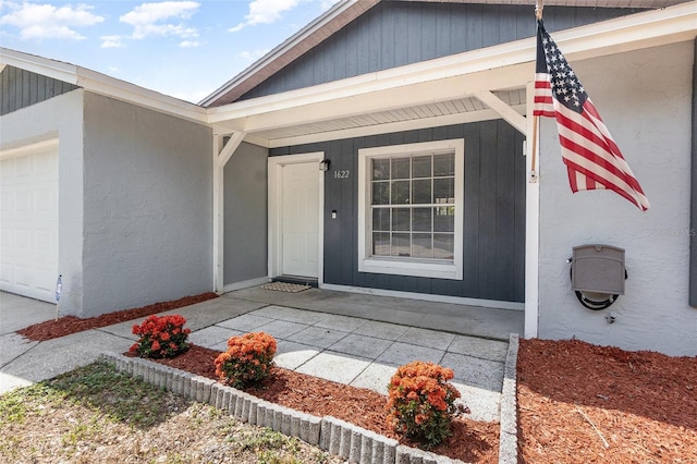 property entrance with an attached garage and a porch