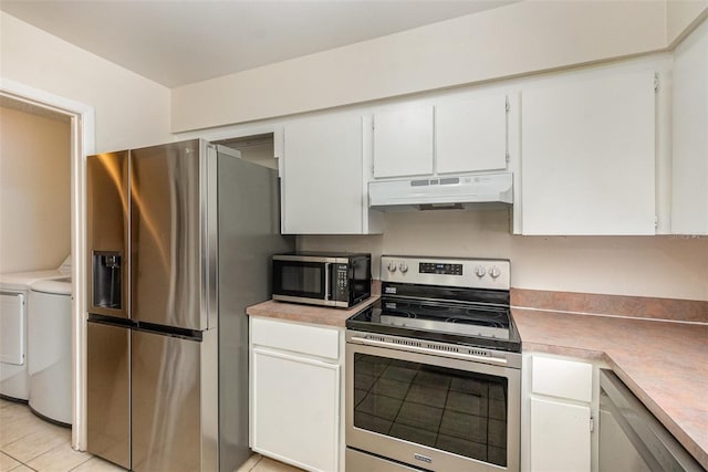 kitchen featuring under cabinet range hood, stainless steel appliances, washer and dryer, and white cabinetry